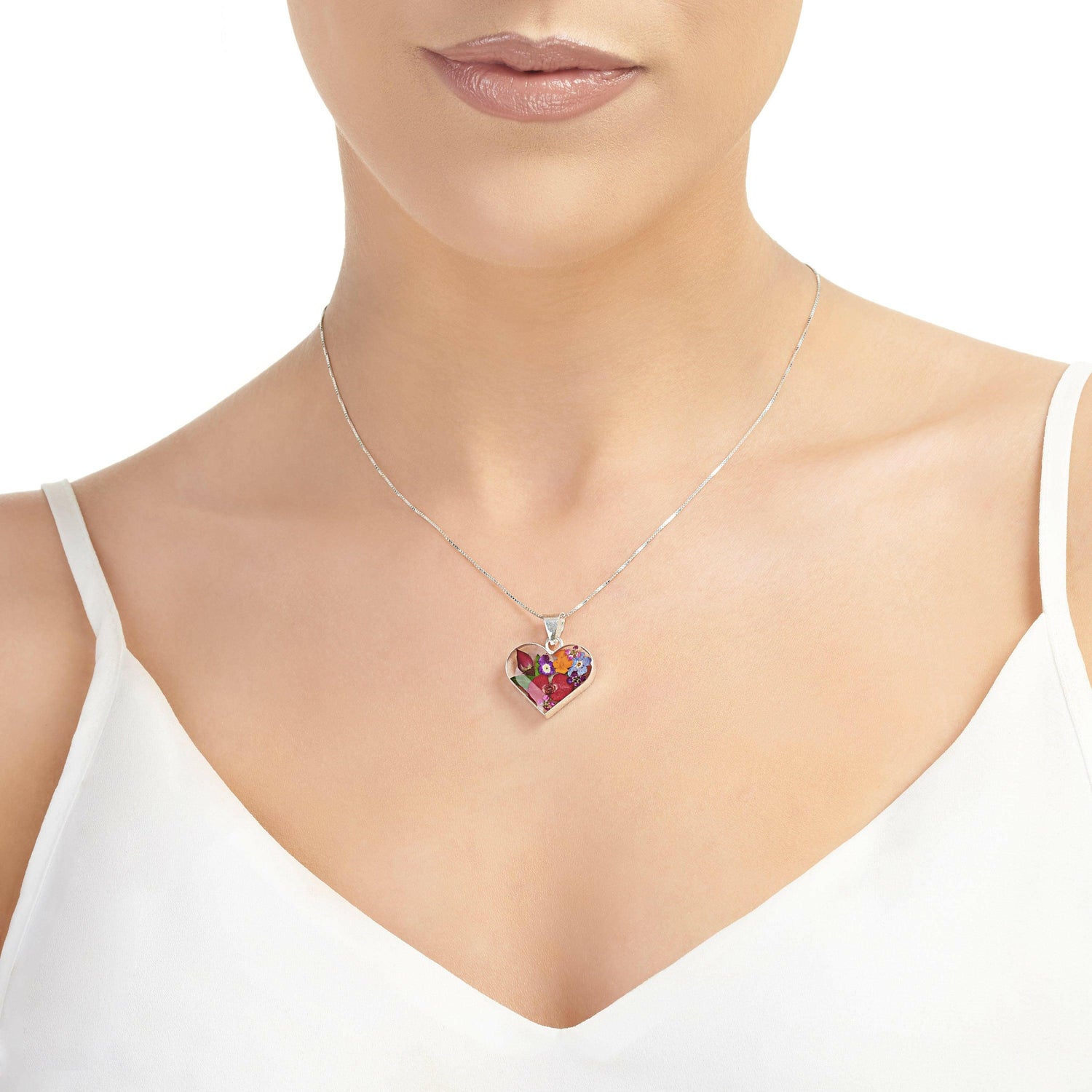 Sterling silver heart-shaped pendant necklace with real flowers.